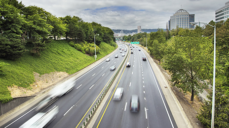 A highway with many cars traveling on it